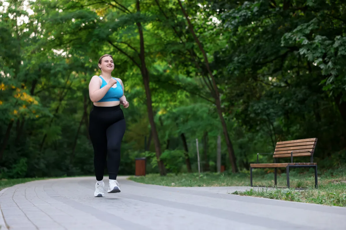 Woman walking on a path in a park